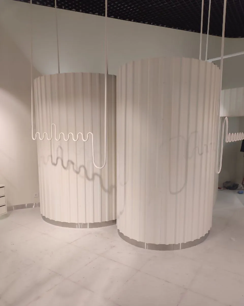 White fluted units with a round cross-section in a bright interior, before finishing